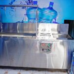 Three taps filling station with inbuilt complete bottle rinser